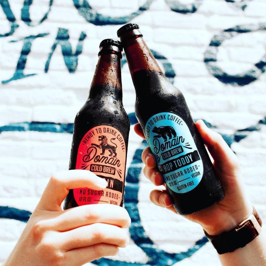 two bottles with orange and blue label designs